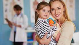 Mother and toddler daughter smiling