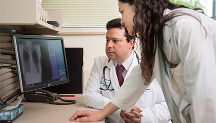 Two physicians preparing education